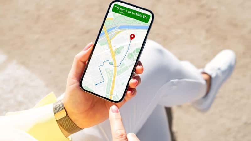 Person viewing city map on mobile phone for navigation directions