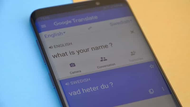 Mandi, Himachal Pradesh, India - 03 05 2021: Photo of translating "What is your name" English to Swedish language on Google translate displaying on smartphone isolated on colored background.