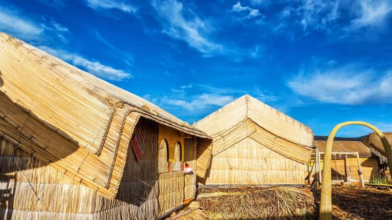 Small houses on Uros floating islands made out of reeds on Lake Titicaca near Puno, Peru