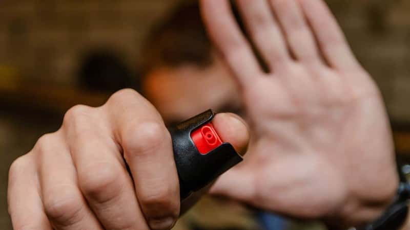 Man holding pepper spray for self defense close up