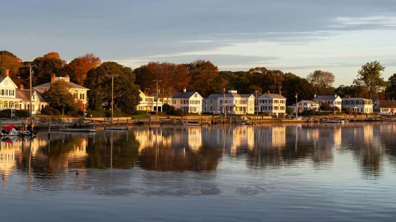 Panoramic view of residential homes by the Mystic River during a vibrant sunrise. Taken in Mystic, Stonington, Connecticut, United States.