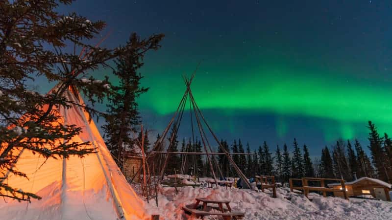 Aurora Borealis, Northern Lights, over aboriginal tent teepee at Yellowknife, Northwest Territories, Canada