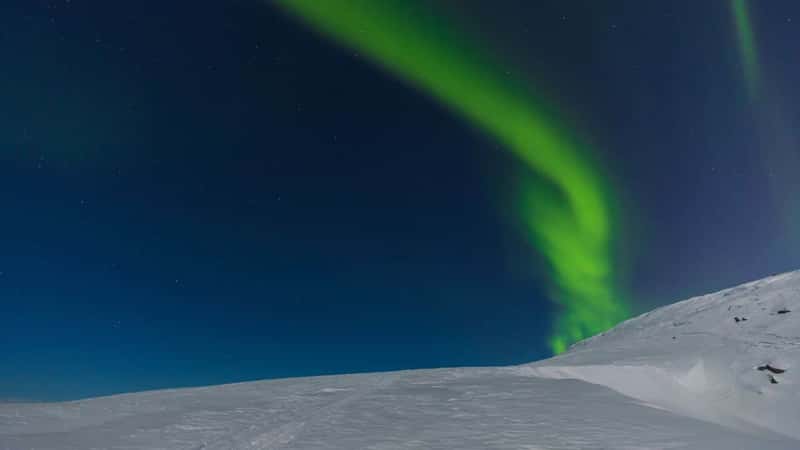 Northern light,aurora borealis over the hills around Kiruna. Lapland, northern part of Sweden.