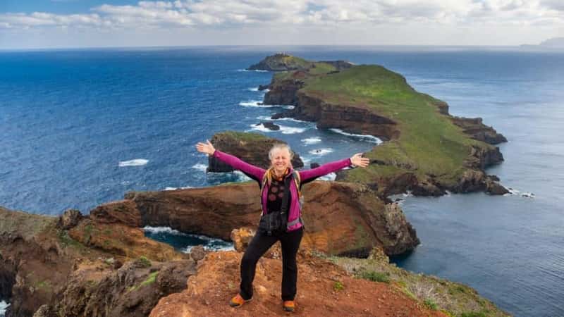 Tourists on hiking path on Ponta de Sao Lourenco Madeira Portugal. Green landscape cliffs and Atlantic Ocean. Ative day, travel background