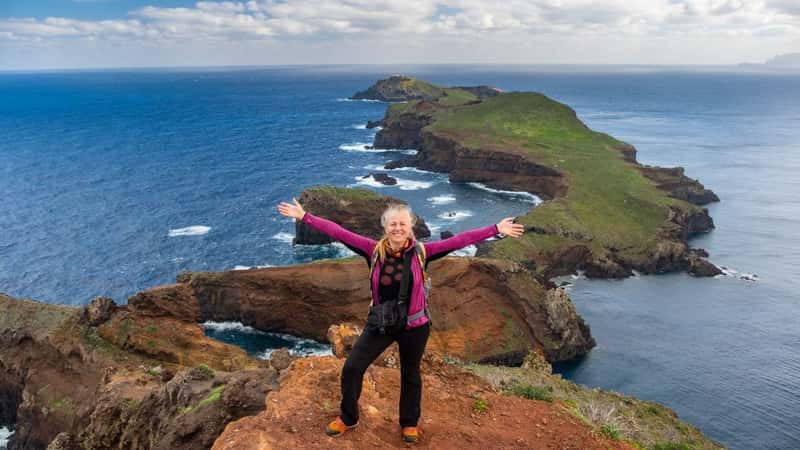 Tourists on hiking path on Ponta de Sao Lourenco Madeira Portugal. Green landscape cliffs and Atlantic Ocean. Ative day, travel background