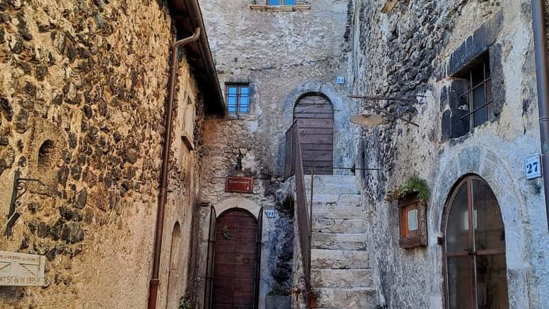 Santo Stefano di Sessanio, Italy - 4-01-2024: Picturesque medieval street with a narrow area between neighboring stone houses. Severe living Middle Ages