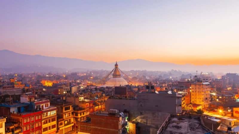 Sunset at the Boudhanath stupa Kathmandu Nepal.Colorful panorama cityscape in twilight sunset.Buddha temple in morning sunrise.Old town of Kathmandu with a Himalaya mountain range background.