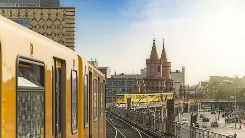 Panoramic view of Berliner U-Bahn trains with Oberbaumbridge in the background in golden evening light at sunset, Berlin Friedrichshain-Kreuzberg, Germany