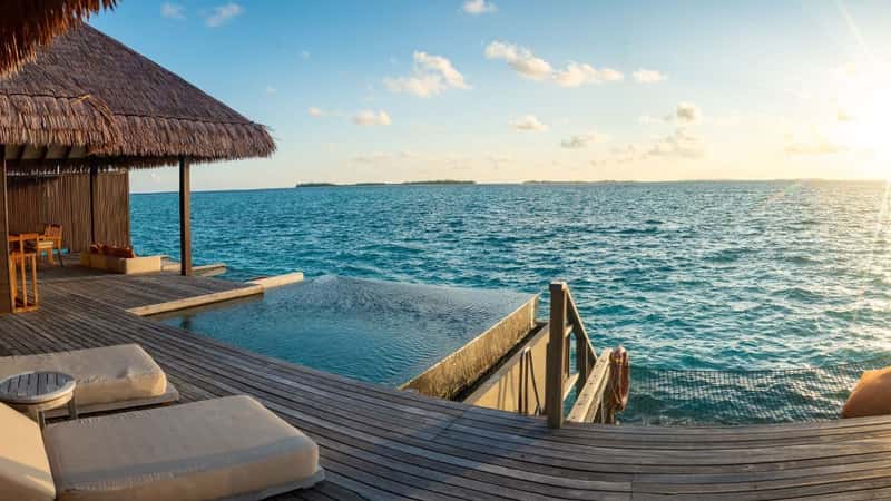 Sunset views from overwater pool villa in Maldives