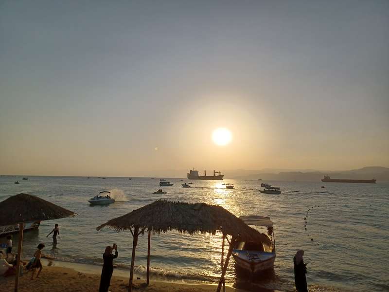sunset over the gulf of aqaba viewed from the public beach in aqaba jordan