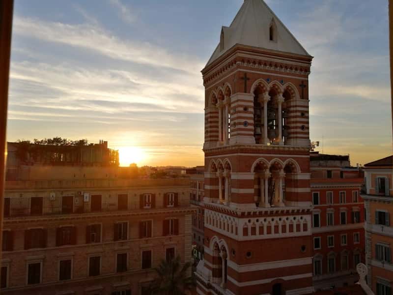 sunset over a bell tower in rome italy