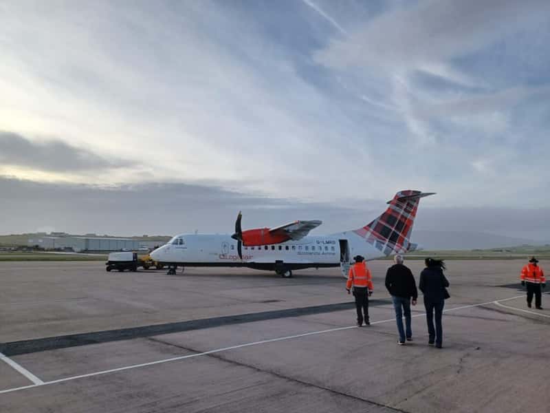 passengers boarding a loganair atr-42 turboprop aircraft on the ramp of sumburgh airport shetland scotland