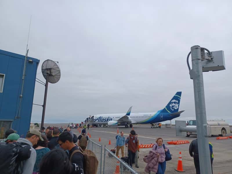 people wait to board an alaska airlines boeing 737 at barrow airport Utqiagvik alaska usa