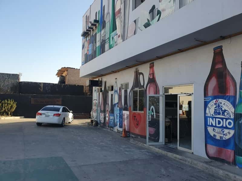 a mural depicting beer bottles on the wall of a restaurant in playas de tijuana baja california mexico