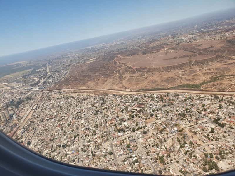 an aerial view of tijuana baja california mexico with the us-mexico border wall in clear view