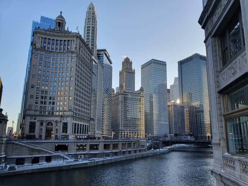 tall buildings next to a river in chicago illinois