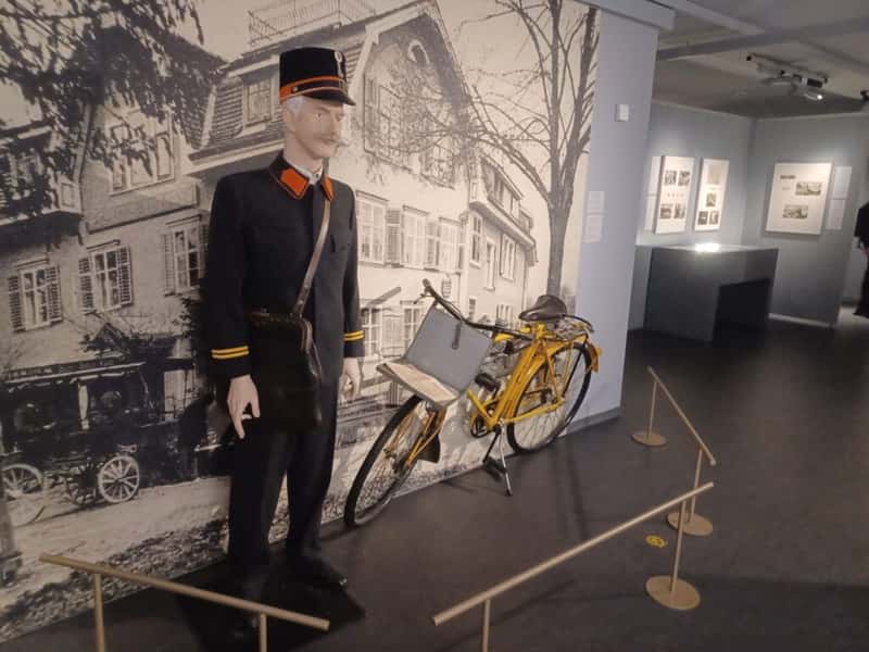a postman and his bike on display at lichtenstein postal museum in vaduz
