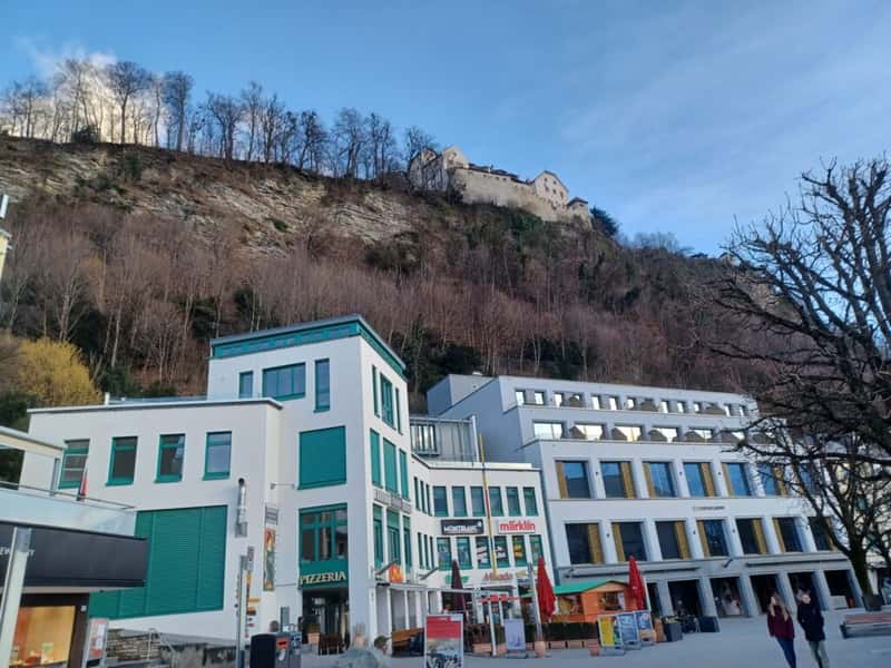 vaduz castle on a hillside above shops in vaduz city centre lichtenstein
