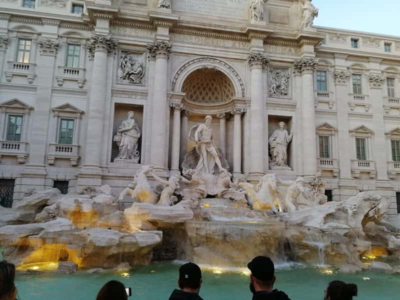 a crowd in front of the trevi fountain in rome italy