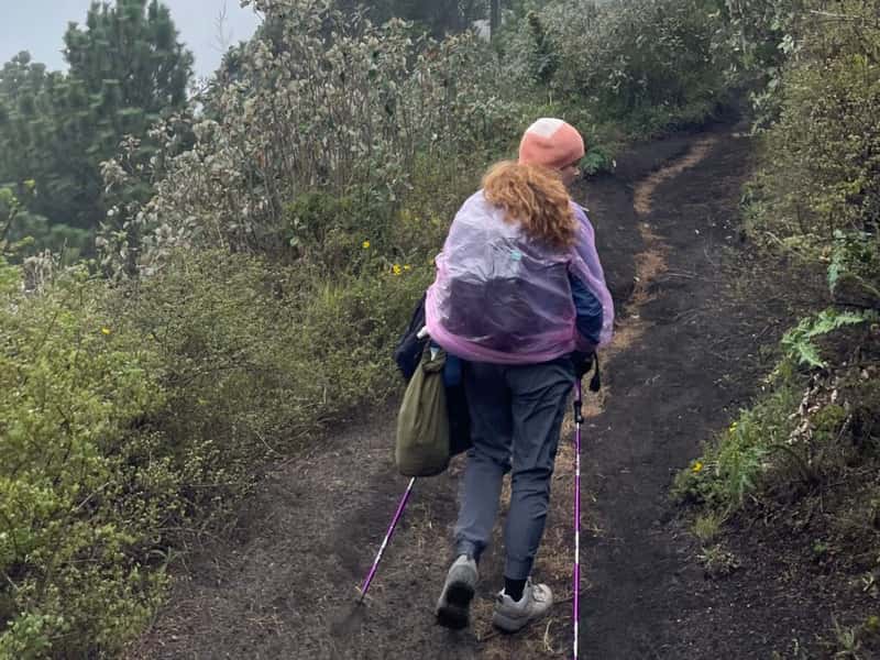 Me with a backpack, rain poncho and warm clothes on the hike