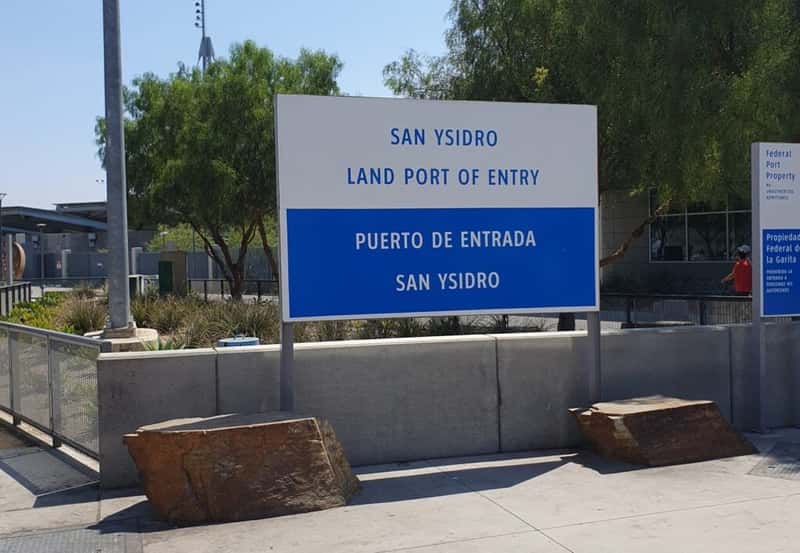 a sign denoting the san ysidro border crossing between san diego california usa and tijuana baja california mexico