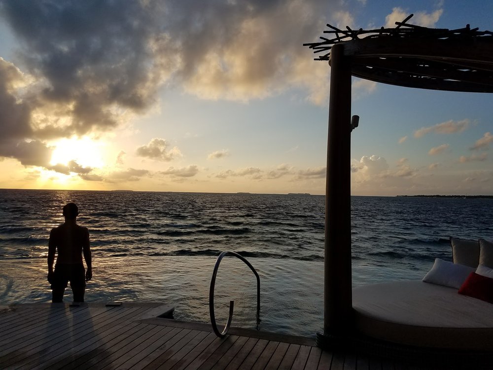 We're dolphin watching around sunset from our overwater villa.&nbsp;
