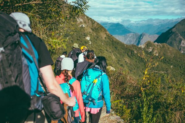 A guide leads a tour up Machu Picchu Mountain