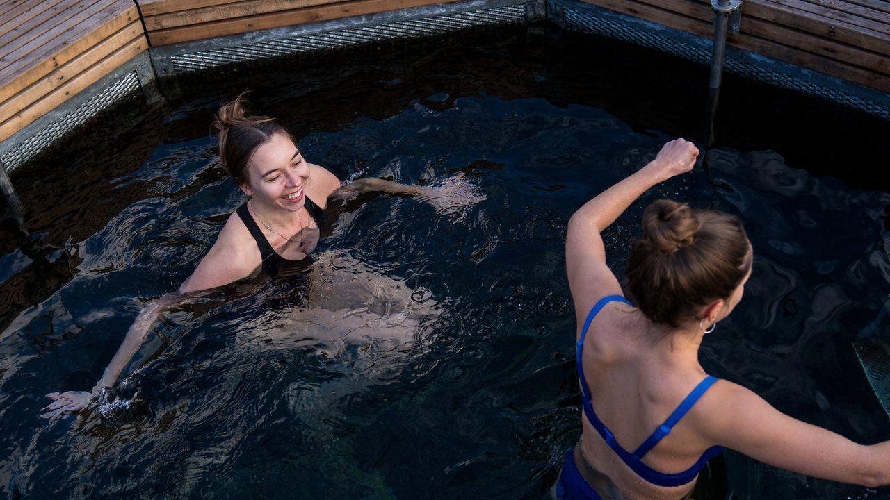 Two women cold plunging